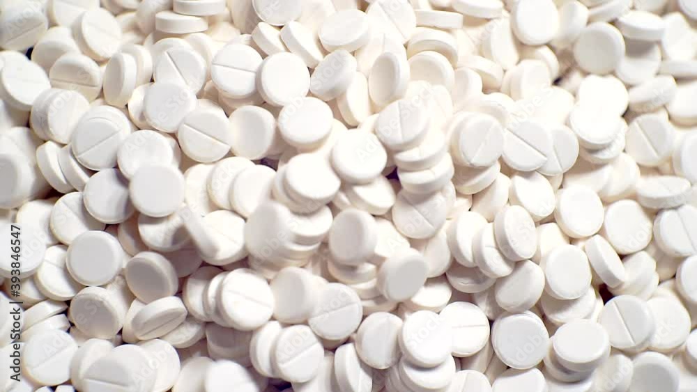 many white round pills.pharmaceutical production. many white round pills.pharmaceutical production.