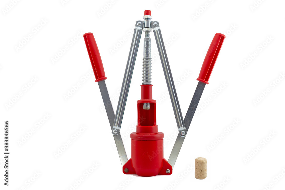 Fototapeta premium Double lever manual wine bottle corker with open levers and a single cork next to it; isolated on white background.