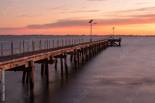 The Robe wooden jetty with orange glow at sunset located in South Australi on November 9th 2020 © Darryl