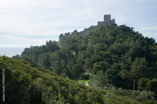 Sesimbra castle with trees all around and the atlantic ocean behind  in Portugal