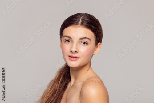 health and beauty concept - Beautiful Young Woman with Clean Fresh Skin touch own face . Facial treatment . Cosmetology , beauty and spa .