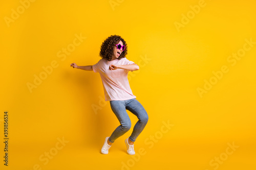 Photo portrait full body view of girl dancing isolated on vivid yellow colored background