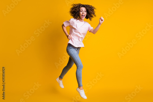 Photo portrait full body view of girl jumping up running isolated on vivid yellow colored background