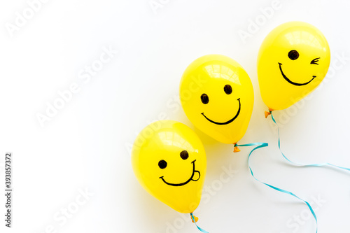 Positive emotions set. Happy and winking emoticons painted on colored balloons