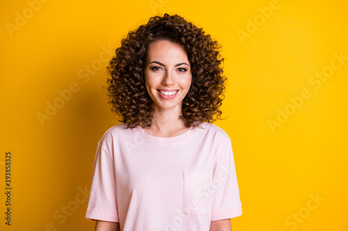 Photo of young positive cheerful curly hair girl happy smile isolated over yellow color background photo