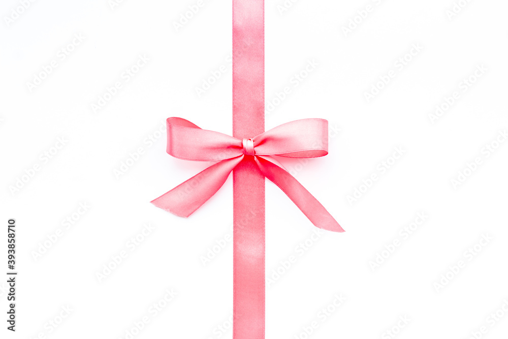 Pink ribbon with bow isolated on white. Top view, copy space Pink ribbon with bow isolated on white. Top view, copy space