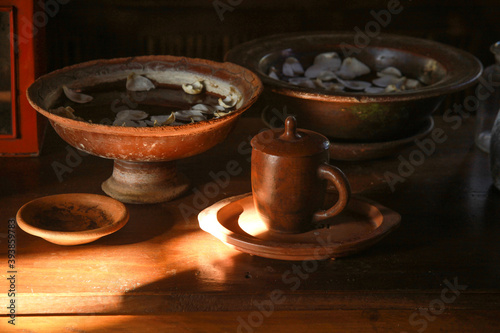 Various handicrafts come from clay such as mug, bowl, plate and tray on wooden table