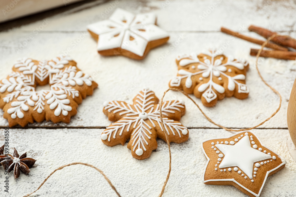 Delicious homemade Christmas cookies and flour on wooden table, closeup