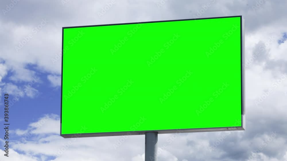 Empty large billboard with a green screen for advertising against blue sky with clouds timelapse Empty large billboard with a green screen for advertising against blue sky with clouds timelapse