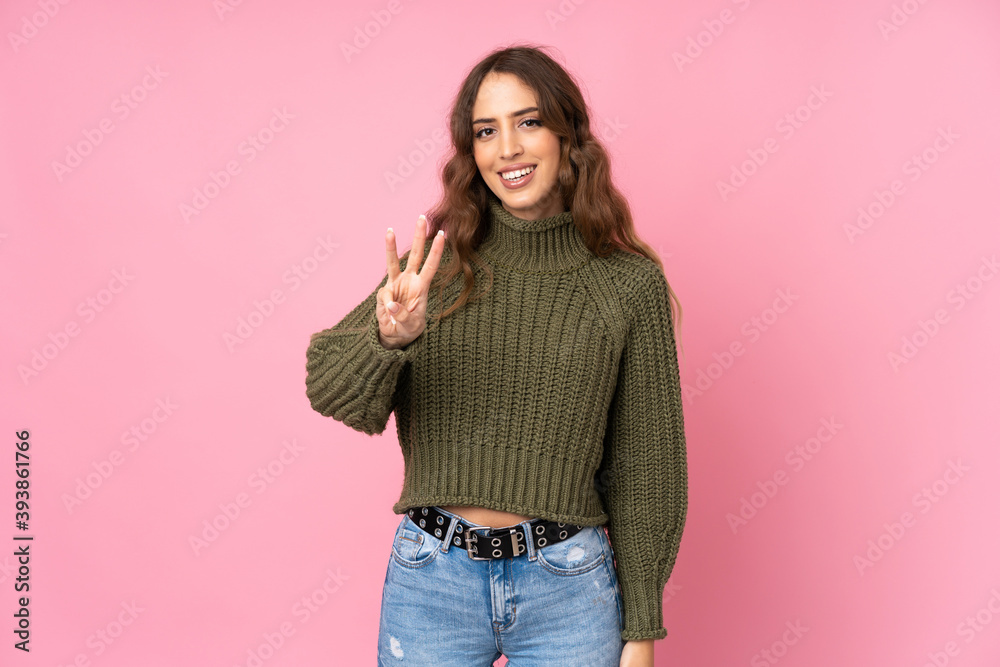 Young woman over isolated pink background happy and counting three with fingers Young woman over isolated pink background happy and counting three with fingers