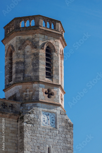 Medieval architecture. Detail of a tower of a castle from stone over the blue sky in the daytime.