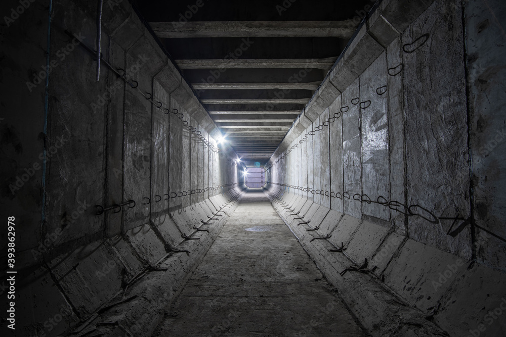 Large empty square reinforced concrete tunnel. Construction of a shallow subway tunnel ventilation.