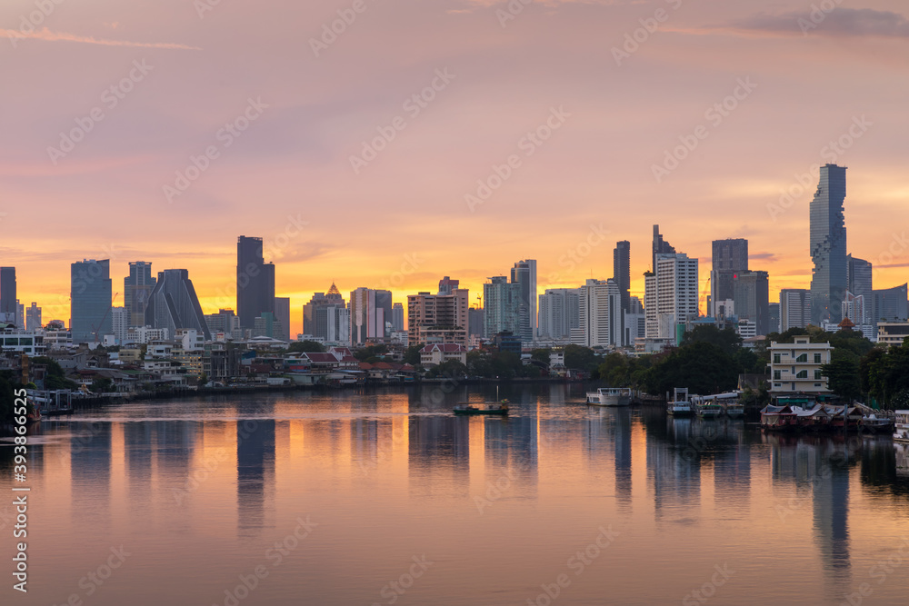 Fototapeta premium Bangkok city center financial business district, waterfront cityscape and Chao Phraya River during twilight before sunrise, Thailand