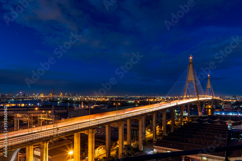 Large suspension bridge over Chao Phraya river with traffic at twilight