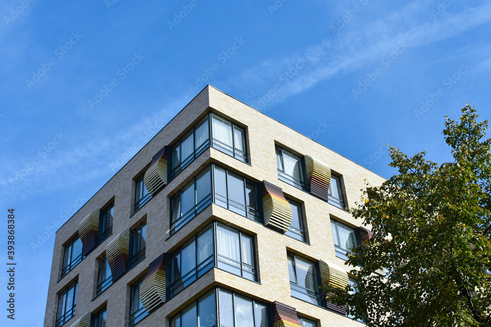 Beautiful modern house with big windows on a background of blue sky. Beautiful modern house with big windows on a background of blue sky.