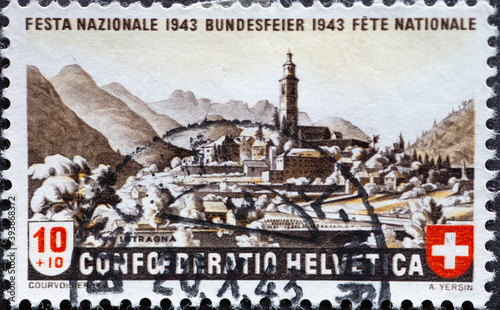 Switzerland - Circa 1943 : a postage stamp printed in the swiss showing a panorama of Intragna in Centovalli (Canton Ticino) Federal celebration of Pro Patria photo