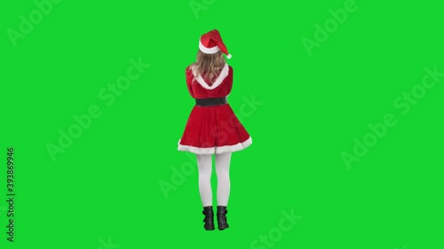 Back view of cheerful Santa Claus girl laughing ho ho ho excited. Full body length on green screen. 