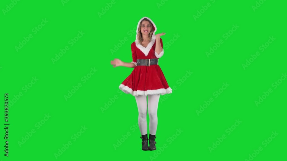 Attractive Santa Claus woman in red costume posing and modelling at camera. Full body length on green screen. Attractive Santa Claus woman in red costume posing and modelling at camera. Full body length on green screen.