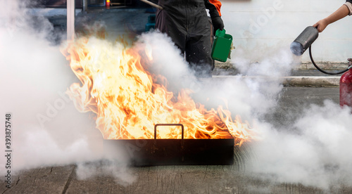 Man teaches or training how to use carbon dioxide (CO2) fire extinguishers to extinguish fires from fuel.