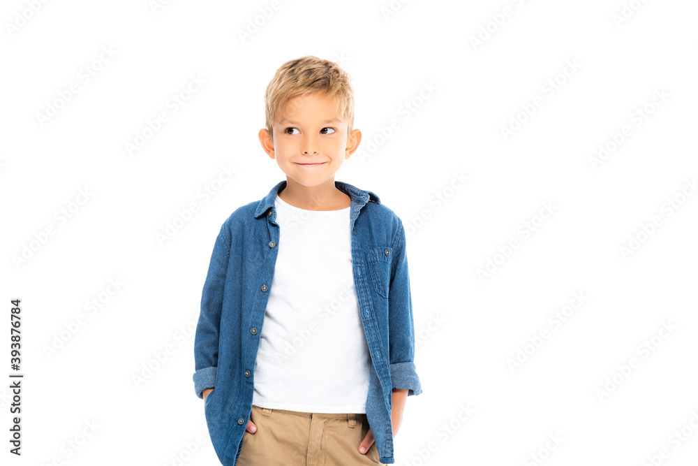 Cheerful boy with hands in pockets of pants looking away isolated on white Cheerful boy with hands in pockets of pants looking away isolated on white