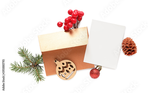 Composition with blank greeting card and Christmas decor on white background, top view. Space for text