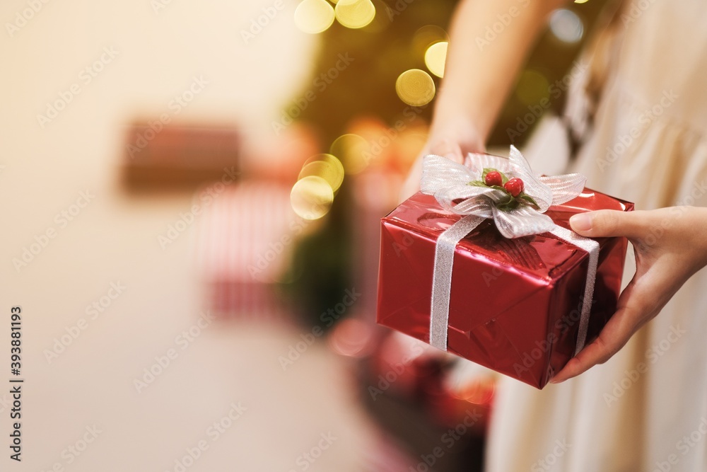 Girl holding a red gift box on christmas day Girl holding a red gift box on christmas day