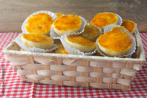 pile of empadas or empadinhas is a very popular and traditional snack of Brazilian cuisine, in a rustic basket on a table lined with a towel photo