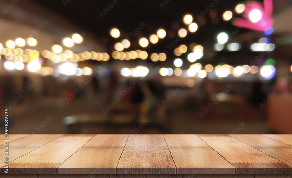 Empty wood table on blur night market background