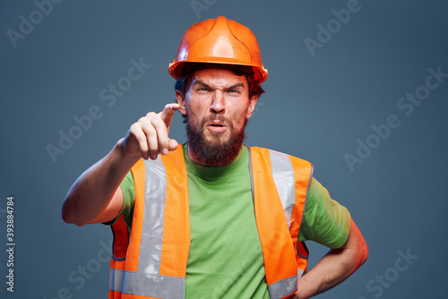 Worker man orange hard hat safety Professional blue background © SHOTPRIME STUDIO
