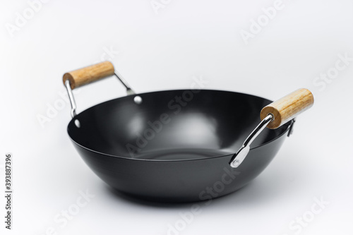 Classic black pan with wooden handle. Isolated on white background