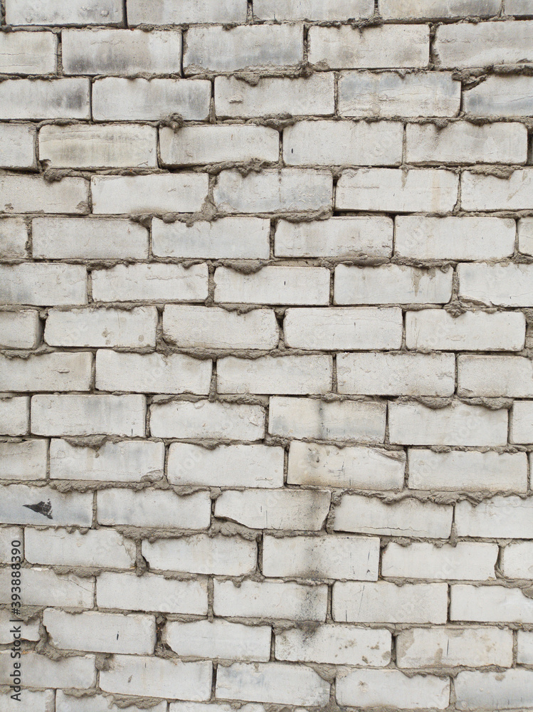 Fototapeta premium texture of rough gray brick wall, with cement between bricks