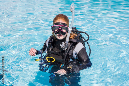 Scuba dive training in a pool with diver looking at the camera with a dive mask on