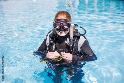 Scuba dive training in a pool with diver looking at the camera with a dive mask on smiling