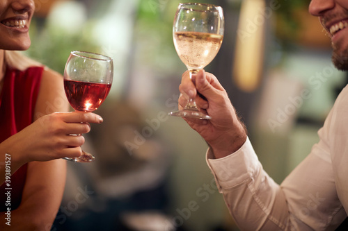 A young couple in love having a drink at Valentine's day celebration in a restaurant. Together, Valentine's day, celebration