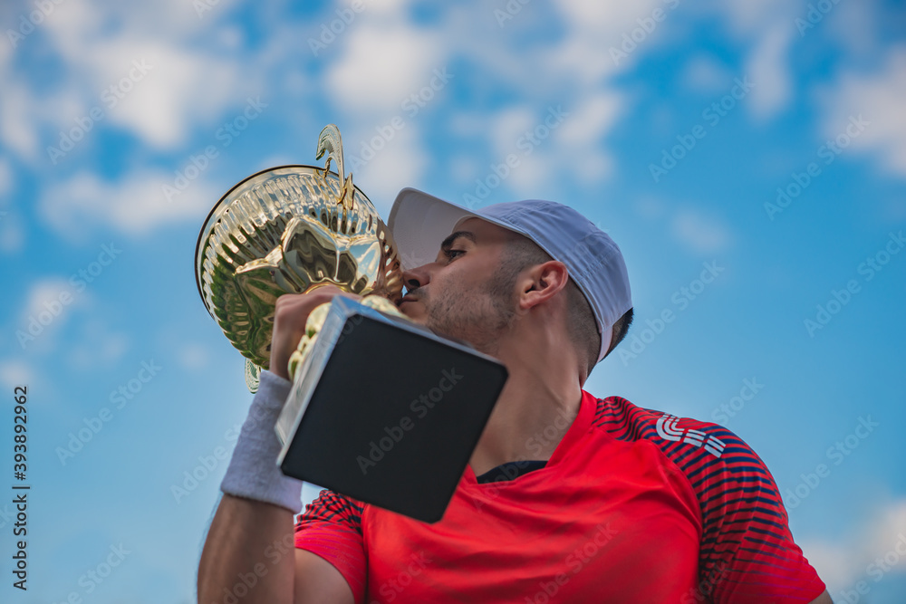 Fototapeta premium Young man holding trophy