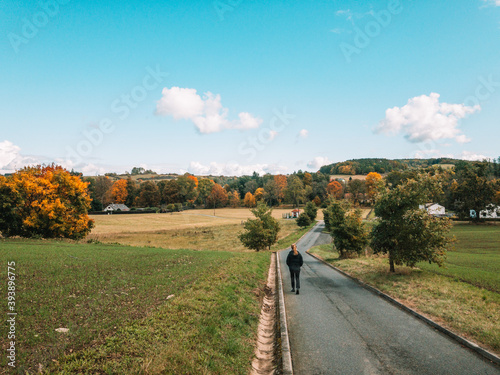 woman taking an autumn walk around the village
