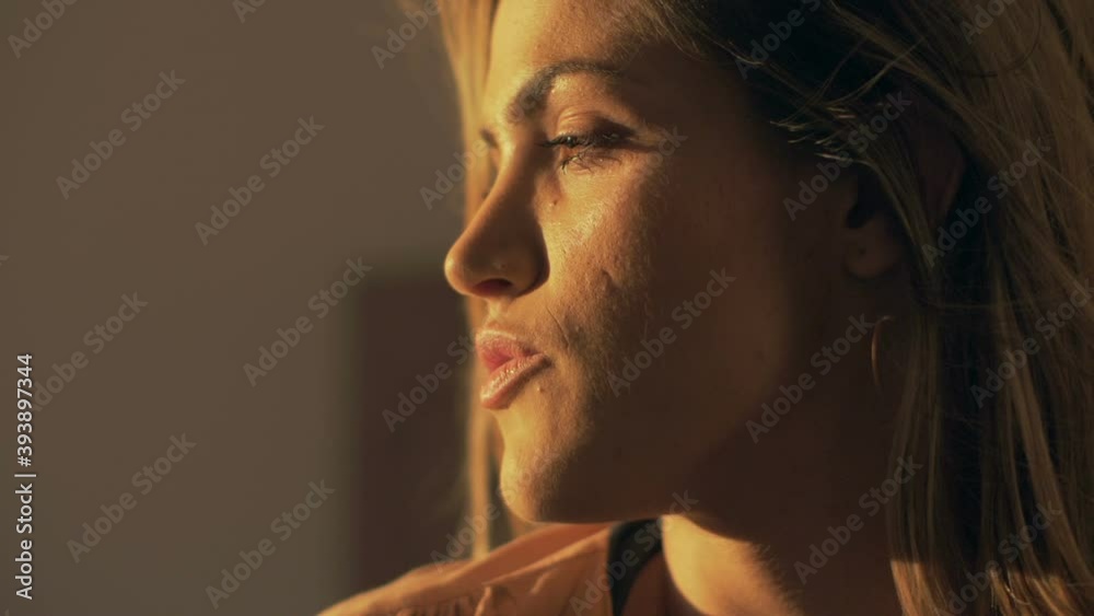Beautiful girl posing by the window, enjoying the sunshine Beautiful girl posing by the window, enjoying the sunshine