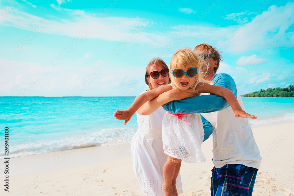happy family with little daughter play on beach happy family with little daughter play on beach