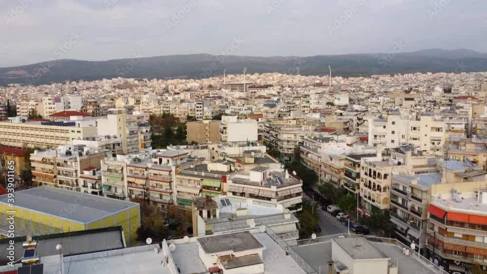 Aerial view of urban environment in the city of Thessaloniki, Greece, east side, road with cars, bottom-up movement by drone 