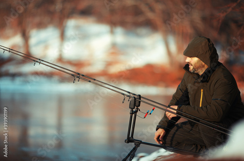 angler carp angler with fishing rods on ice fishing