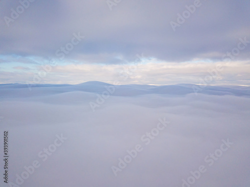 High aerial flight between fog and clouds. © Sergey