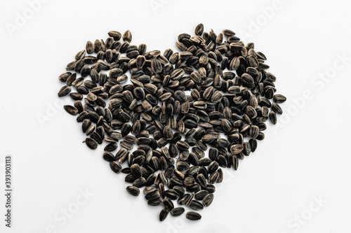 Fotografie Sunflower seeds on white background