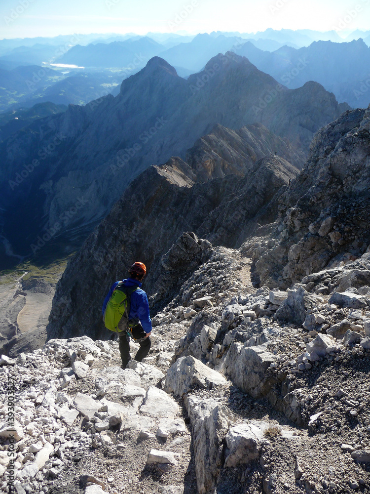 Hiker at climbing route Jubilaumsgrat to Zugspitze mountain, Germany Hiker at climbing route Jubilaumsgrat to Zugspitze mountain, Germany