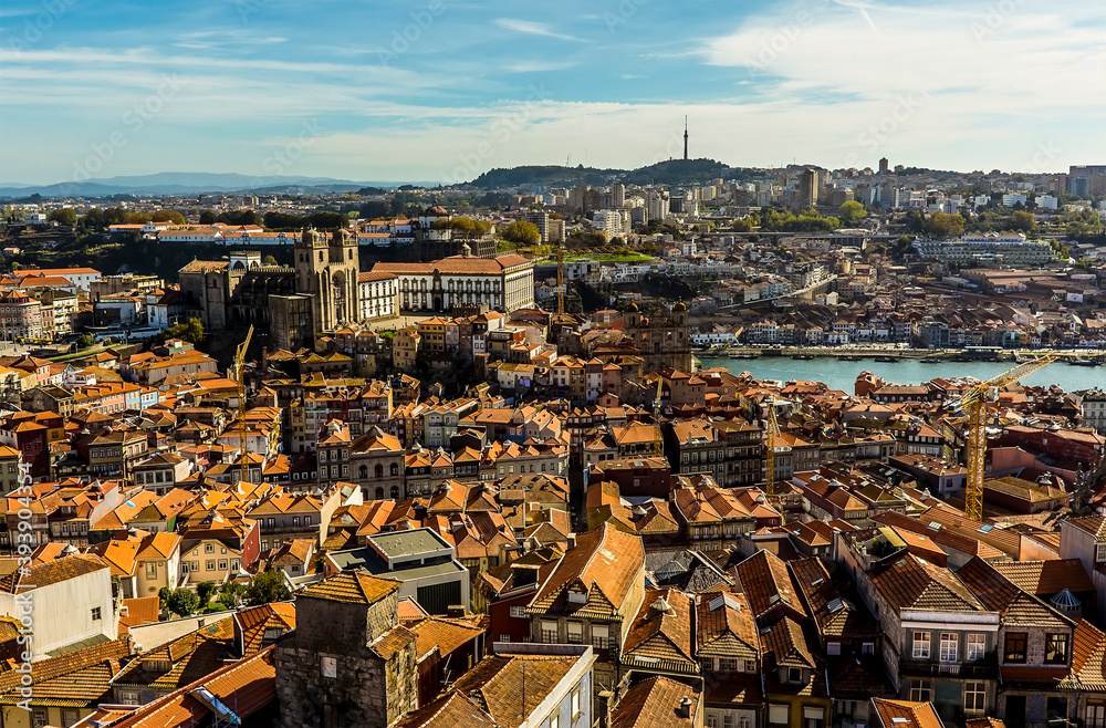 A view towards the cathedral across the roof tops of Porto, Portugal from the Clerigos Tower on a sunny afternoon