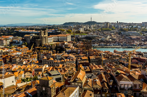 A view towards the cathedral across the roof tops of Porto, Portugal from the Clerigos Tower on a sunny afternoon