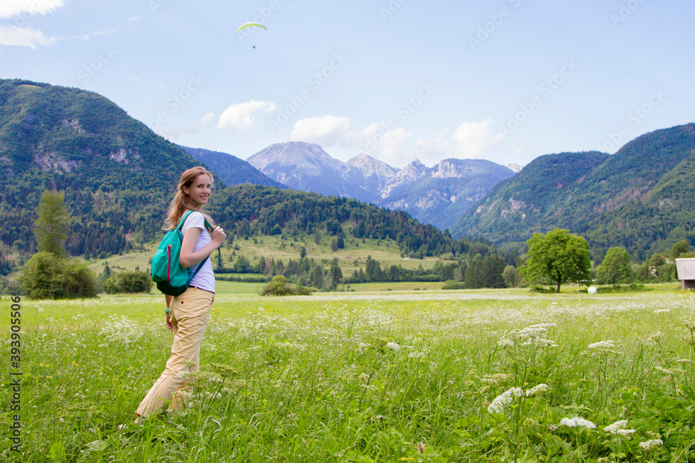 The beautiful woman walking on the Alpine meadows. The beautiful woman walking on the Alpine meadows.