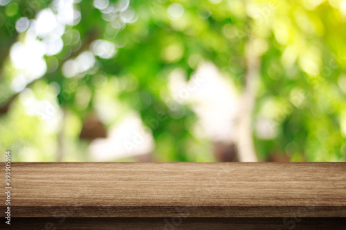 wooden table and nature green bokeh background