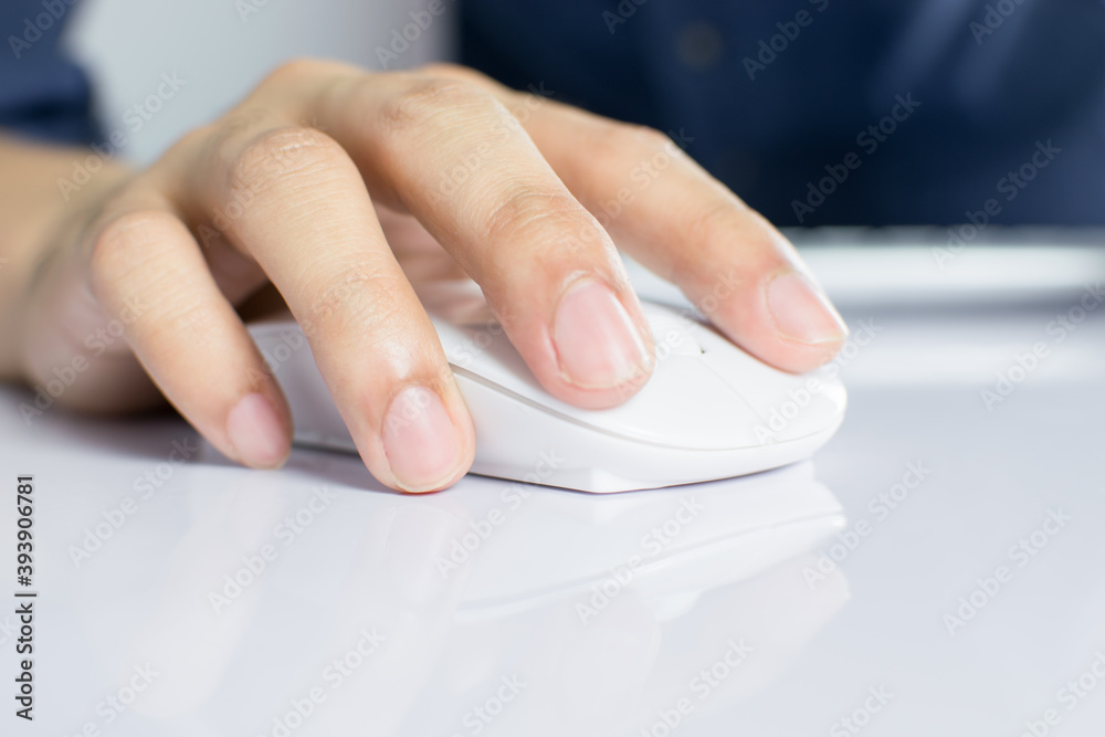 Business People Clicking wireless digital mouse with digital tablet on office table.