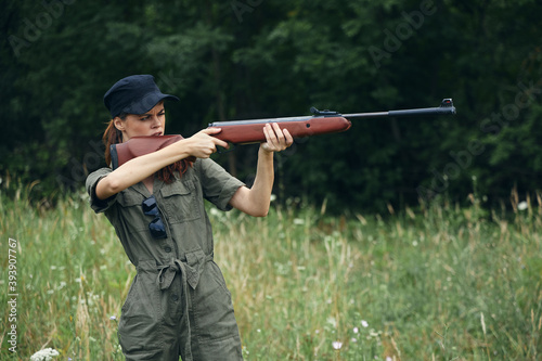 Woman Holds guns in front of him aiming side view weapons 