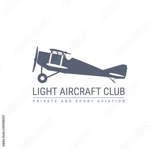 Light aviation emblem with retro airplane, biplane side view, propeller aircraft logo, vector illustration